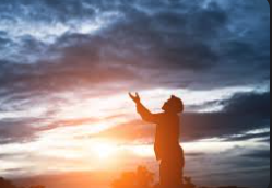 A person praying at sunset — the witness of faithful Catholics remains the Church's most powerful argument